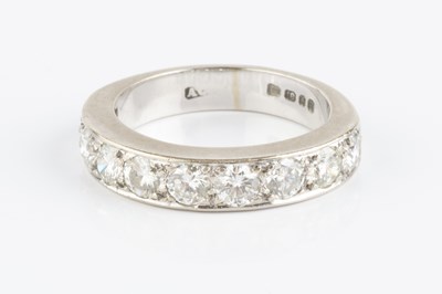 Lot 131 - A diamond half hoop ring, the line of uniform...