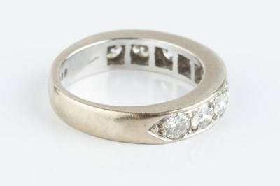 Lot 131 - A diamond half hoop ring, the line of uniform...