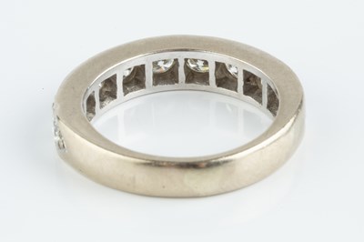 Lot 131 - A diamond half hoop ring, the line of uniform...
