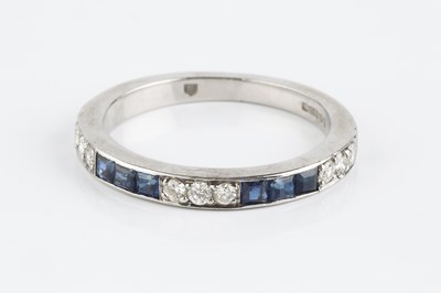 Lot 130 - A sapphire and diamond half hoop ring,...