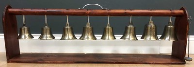 Lot 190 - Eight antique chiming bells mounted on a 20th...