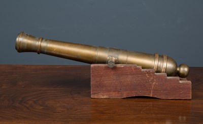 Lot 60 - An old brass model or signalling cannon, on a...