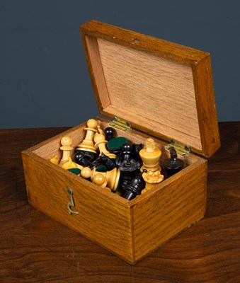 Lot 124 - A turned ebony and boxwood chess set, the king...