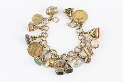 Lot 8 - A charm bracelet, the 9ct gold fancy-link...
