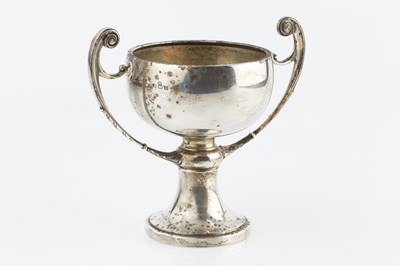 Lot 394 - A silver twin handled trophy cup, on spreading...