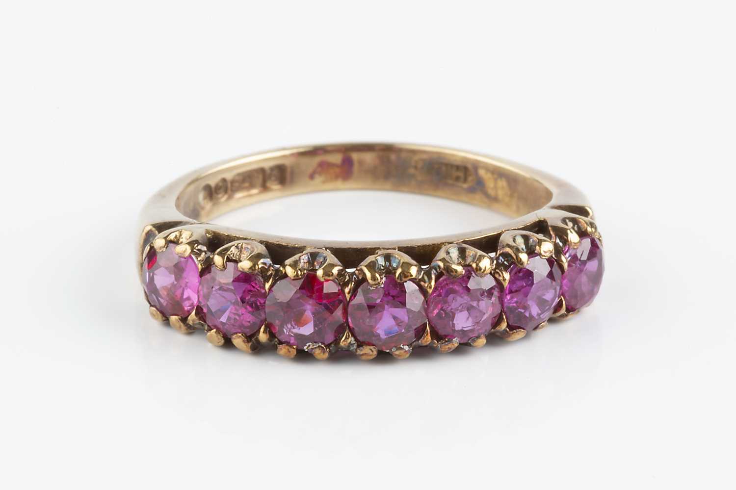 Lot 90 - A ruby half hoop ring, designed as a line of...
