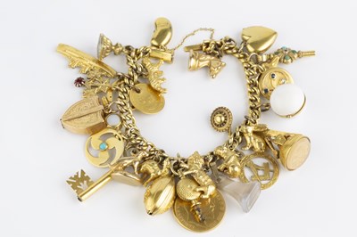 Lot 45 - A charm bracelet, the yellow precious metal...