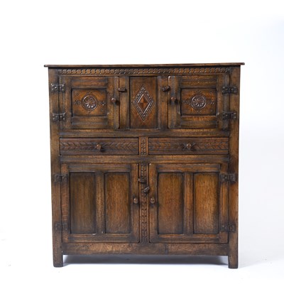 Lot 74 - Jacobean style oak cupboard with panel carved...