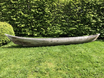 Lot 685 - An antique dugout canoe, with two paddles,...