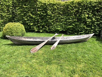 Lot 685 - An antique dugout canoe, with two paddles,...