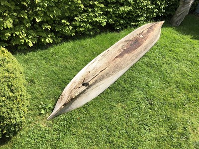 Lot 685 - An antique dugout canoe, with two paddles,...