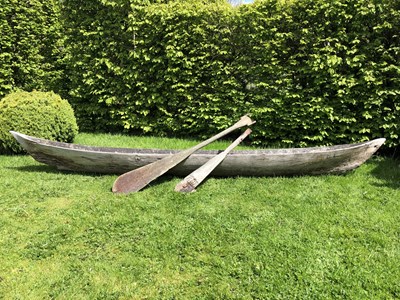 Lot 685 - An antique dugout canoe, with two paddles,...