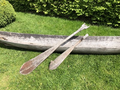 Lot 685 - An antique dugout canoe, with two paddles,...