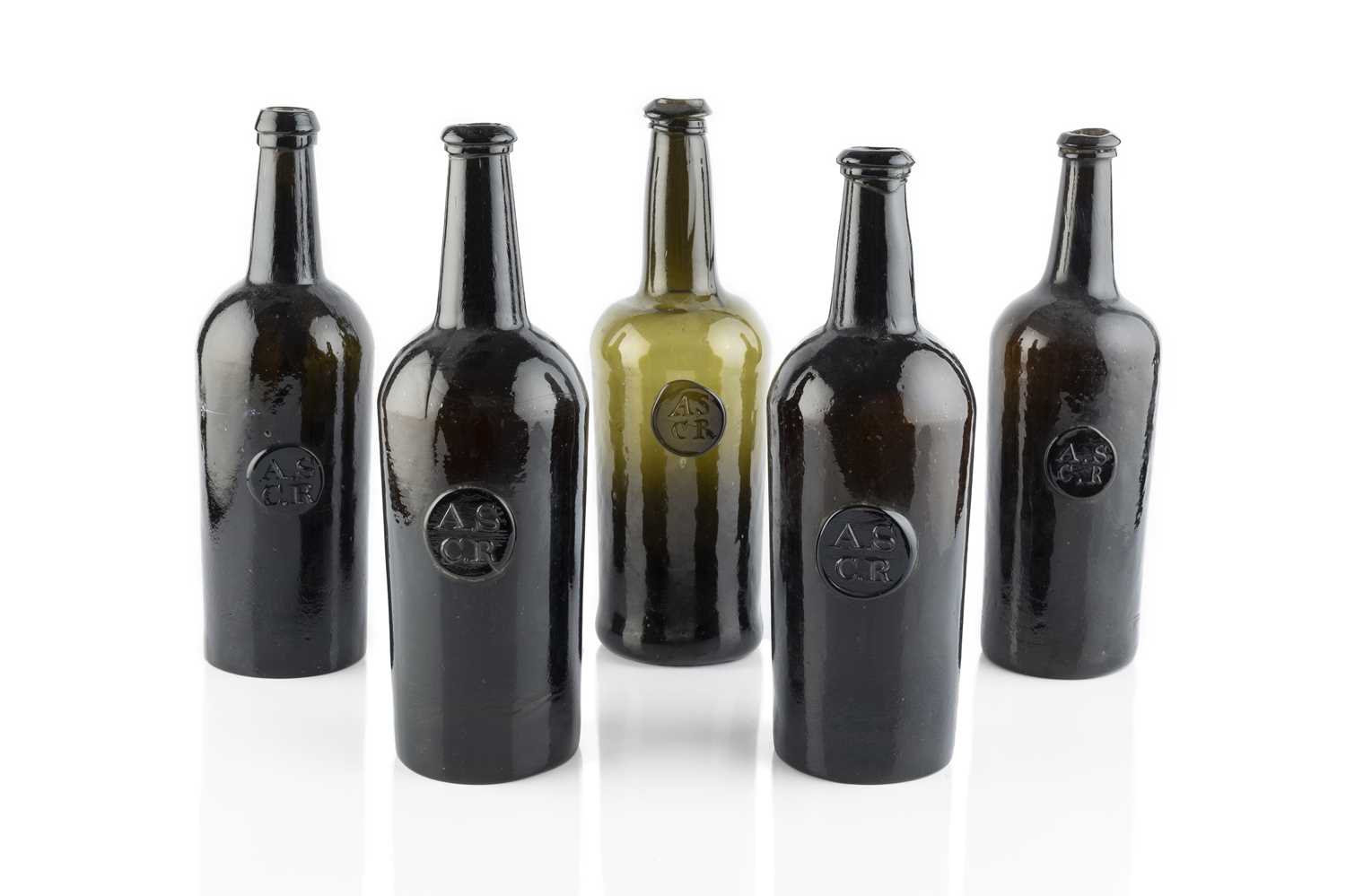 Lot 102 - A group of five sealed wine bottles, cylinders,...