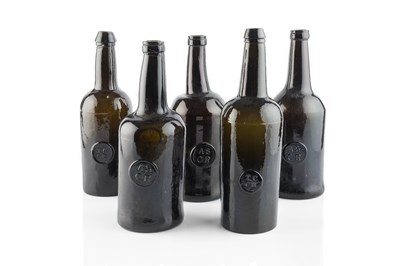 Lot 106 - A group of five sealed wine bottles, cylinders,...