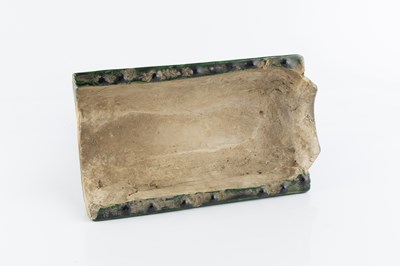 Lot 174 - A Chinese Tang style pottery ridge tile, in...