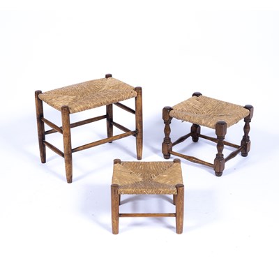 Lot 38 - Cotswold School three rush seated stools, the...