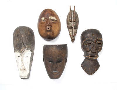 Lot 312 - Tribal interest, a group of five masks, all...