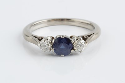 Lot 141 - A sapphire and diamond three stone ring, the...