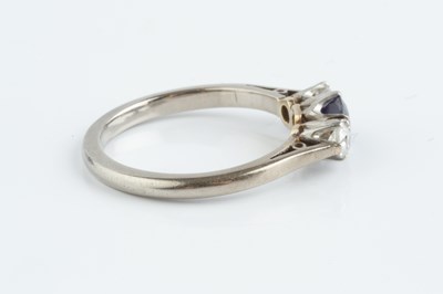 Lot 141 - A sapphire and diamond three stone ring, the...