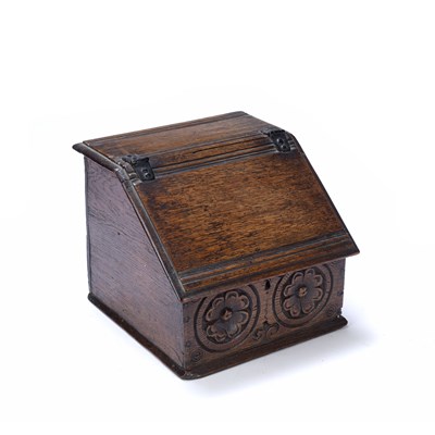 Lot 250 - An antique oak candle box, with hinged sloping...