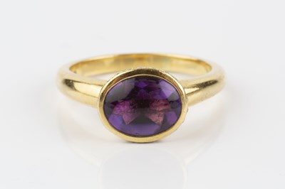 Lot 178 - An amethyst and diamond dress ring, the oval...