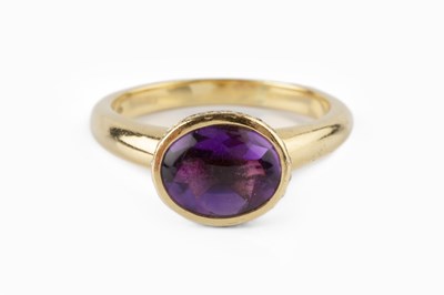 Lot 49 - An amethyst and diamond dress ring, the oval...