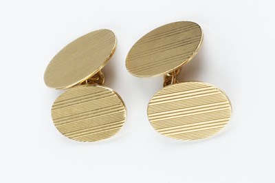 Lot 42 - A pair of 9ct gold cufflinks, the oval panels...