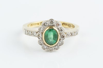 Lot 115 - An emerald and diamond cluster ring, the oval...