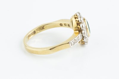 Lot 115 - An emerald and diamond cluster ring, the oval...