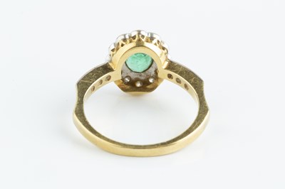 Lot 115 - An emerald and diamond cluster ring, the oval...
