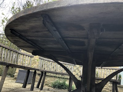 Lot 688 - A large circular oak garden table and eight...