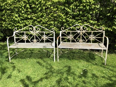 Lot 689 - A pair of wrought iron benches, with scroll...