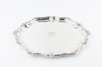 Lot 411 - A silver salver, the shaped and reeded border...