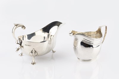 Lot 415 - A silver sauce boat, with scroll handle, on...