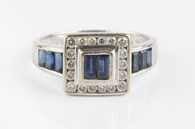 Lot 78 - A sapphire and diamond cluster ring, centred...