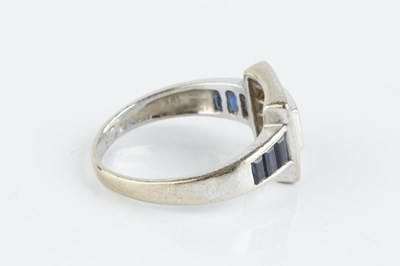 Lot 78 - A sapphire and diamond cluster ring, centred...
