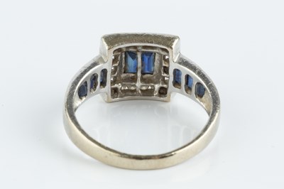 Lot 78 - A sapphire and diamond cluster ring, centred...