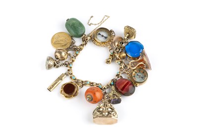 Lot 9 - A charm bracelet, the fancy curb-link bracelet...