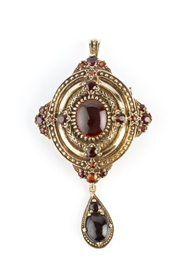 Lot 35 - A garnet set pendant/brooch, the shaped oval...