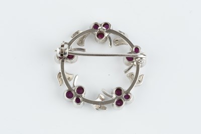 Lot 89 - A ruby and diamond wreath brooch, designed as...