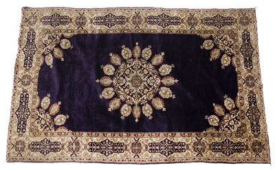 Lot 373 - A Kashmiri purple ground rug with central...