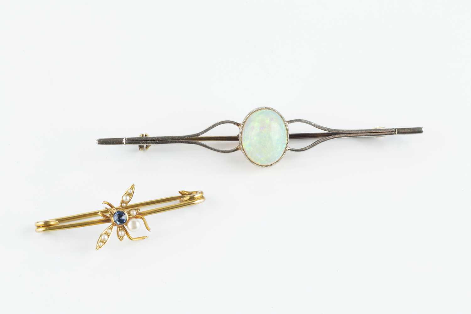 Lot 86 - An opal single stone bar brooch, the oval...