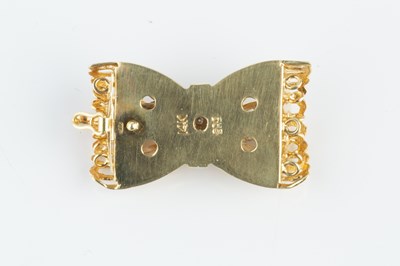 Lot 133 - A diamond set clasp, modelled as a fluted...