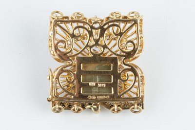 Lot 71 - A ruby and diamond set clasp, modelled as a...