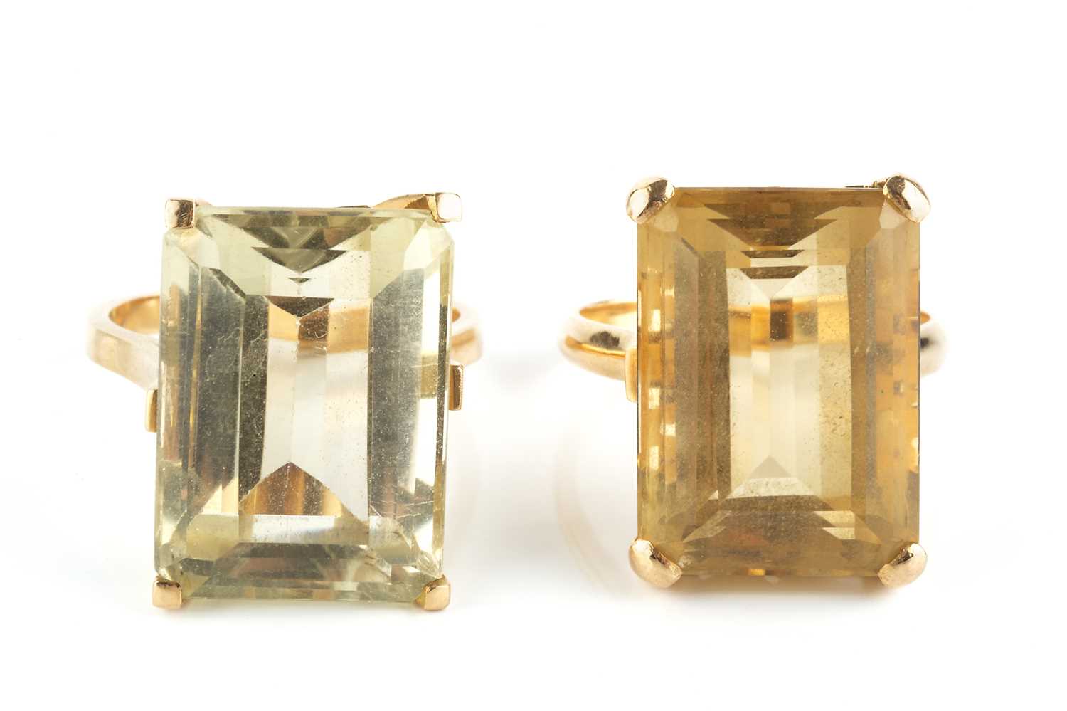 Lot 32 - Two citrine single stone dress rings, each...