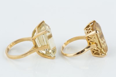 Lot 32 - Two citrine single stone dress rings, each...