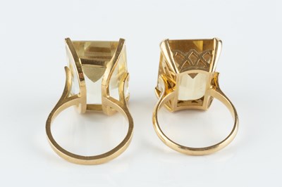 Lot 32 - Two citrine single stone dress rings, each...