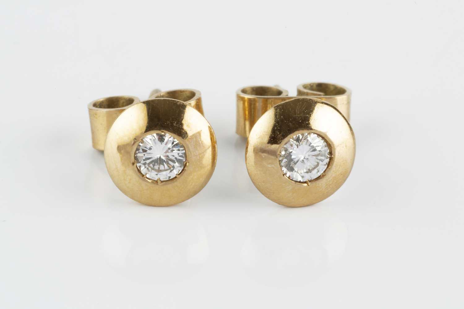 Lot 79 - A pair of diamond ear studs, each round...