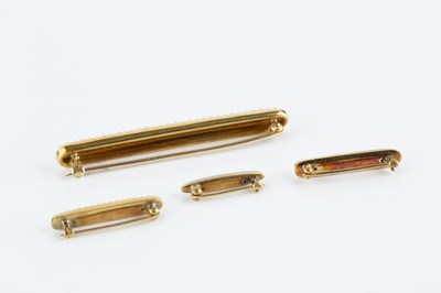 Lot 49 - A collection of enamel and half pearl bar...